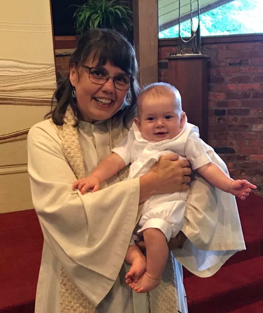 Rev. Michelle holds a baby
